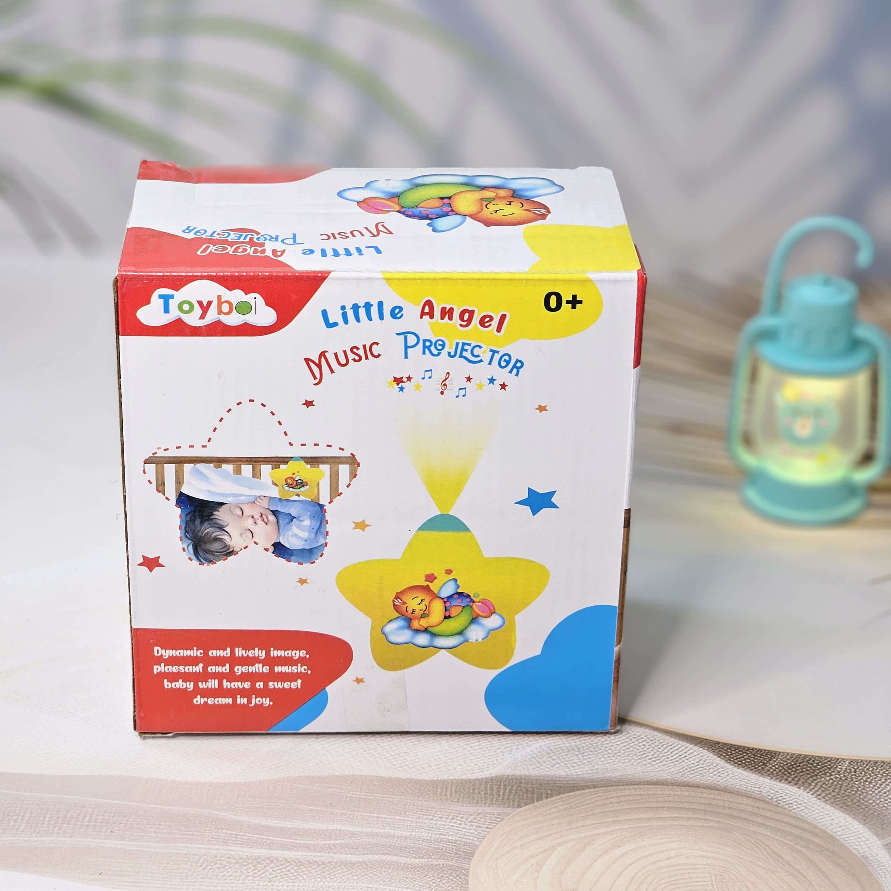 Baby night light star projector in yellow and teal, designed to comfort newborn babies to sleep. www.usmile.toys