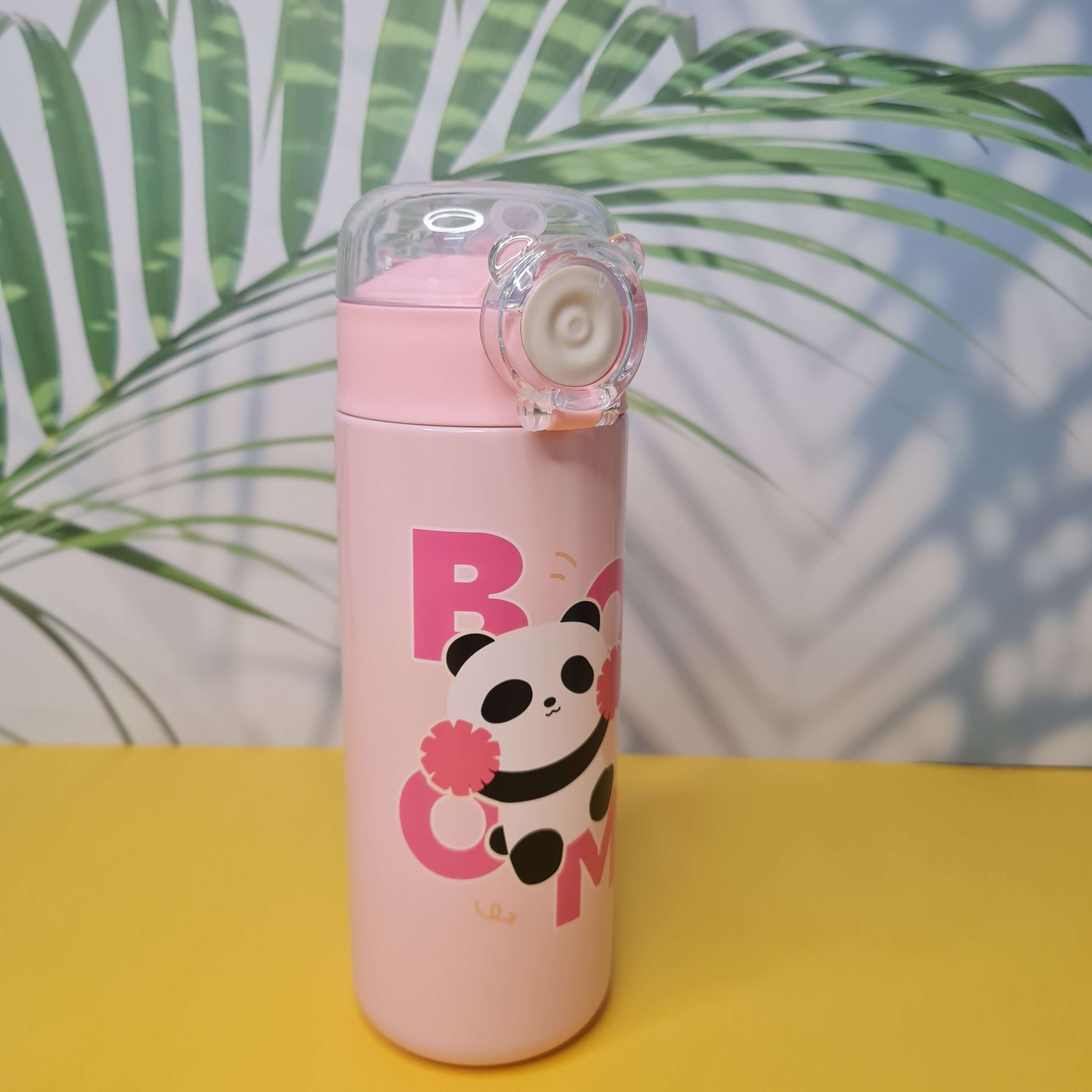Pink water bottle with panda design on a yellow background