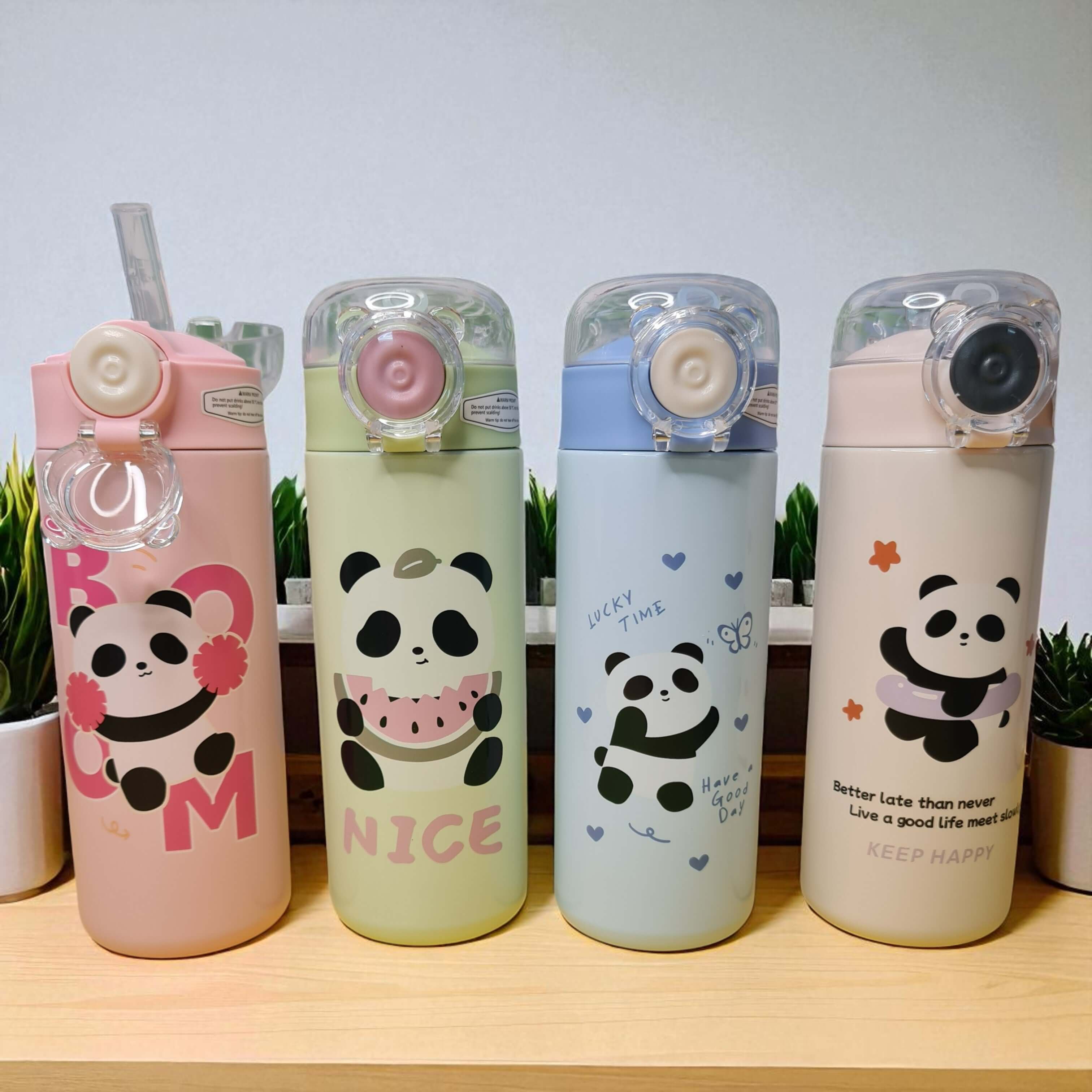 Four panda-themed water bottles on a wooden surface with a light gray background.