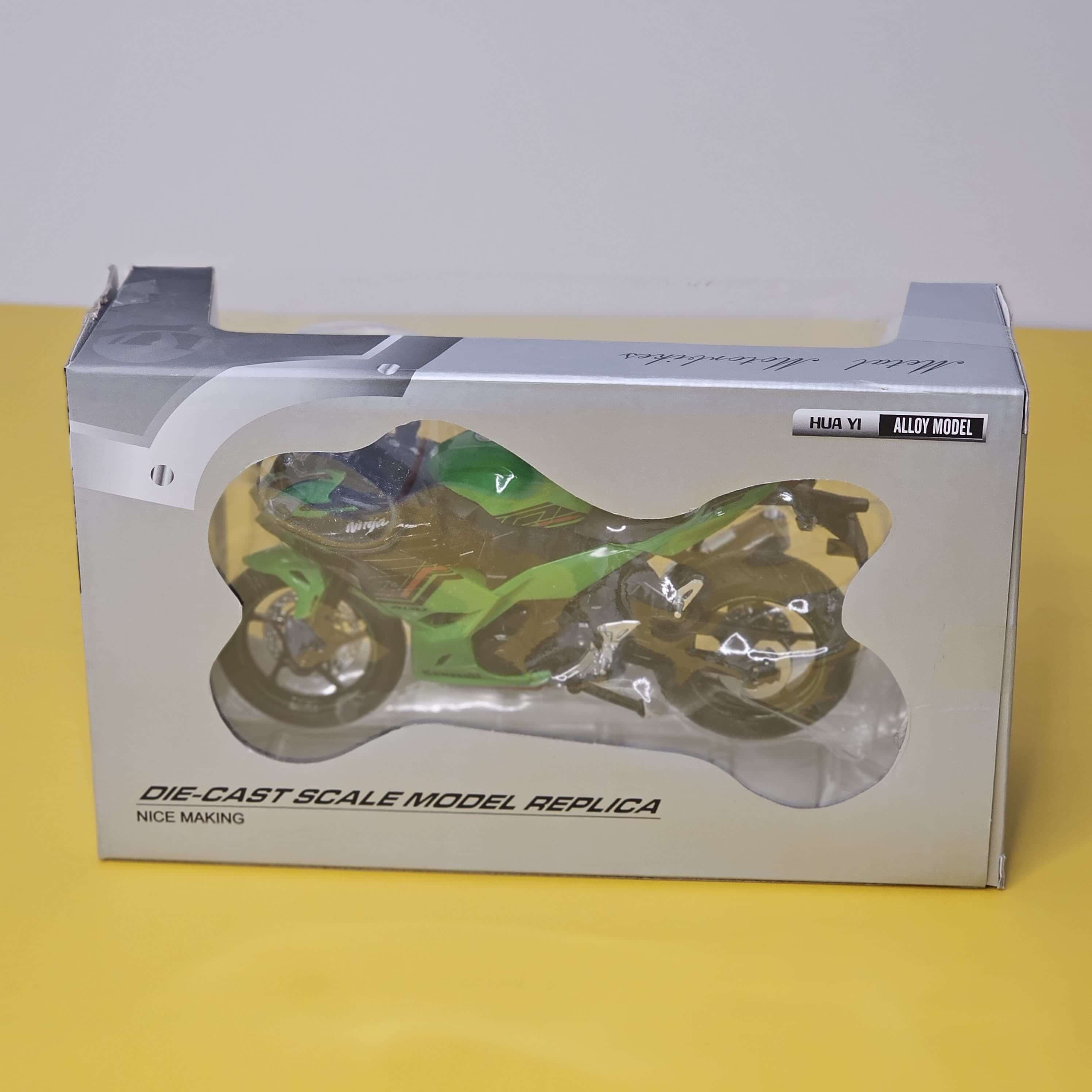 Front view of a bright green die-cast Kawasaki Ninja sports bike toy, showcasing its realistic design and working LED headlights, perfect for kids' playtime from Usmile Toys.www.usmile.toys