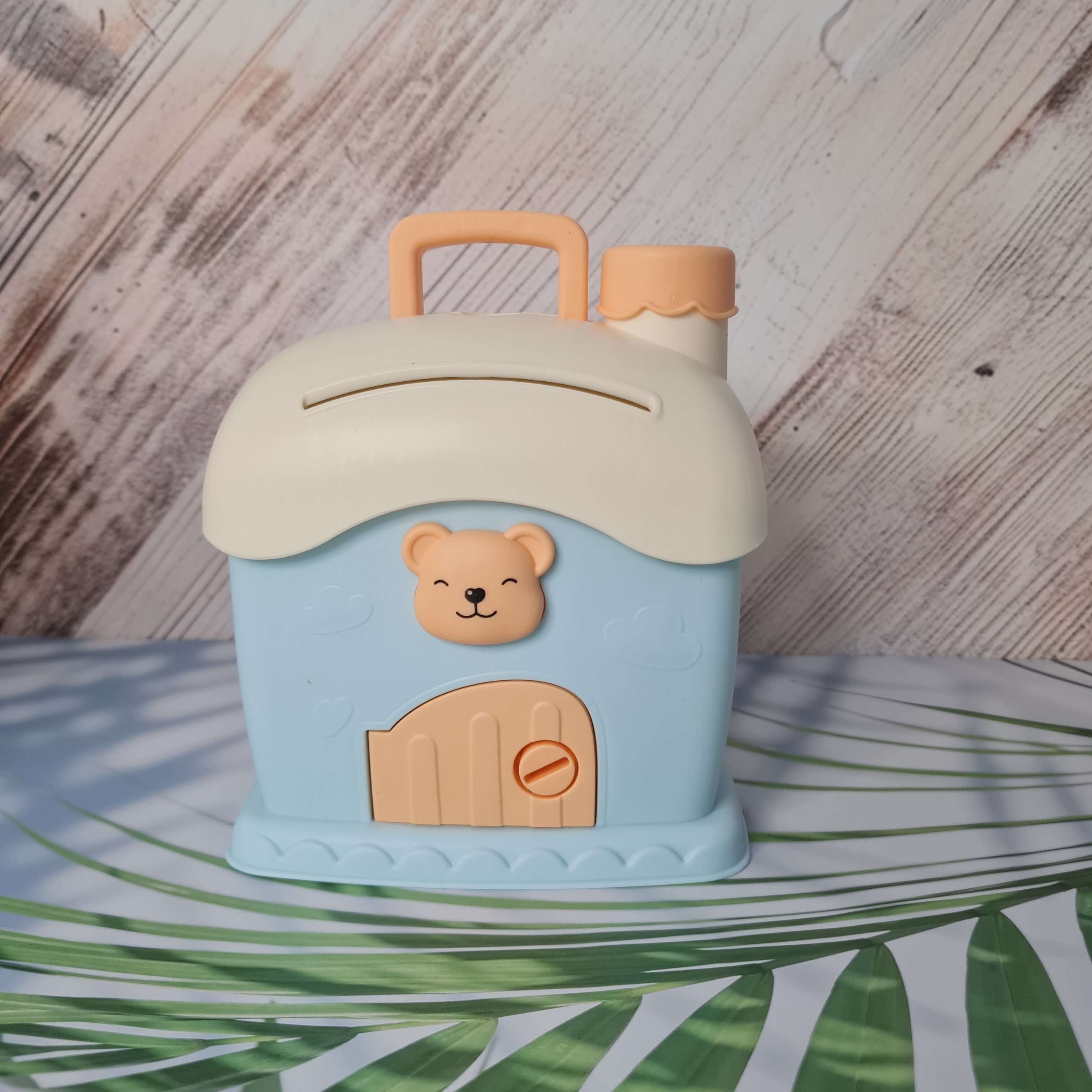 Children's cup with bear design on a wooden surface