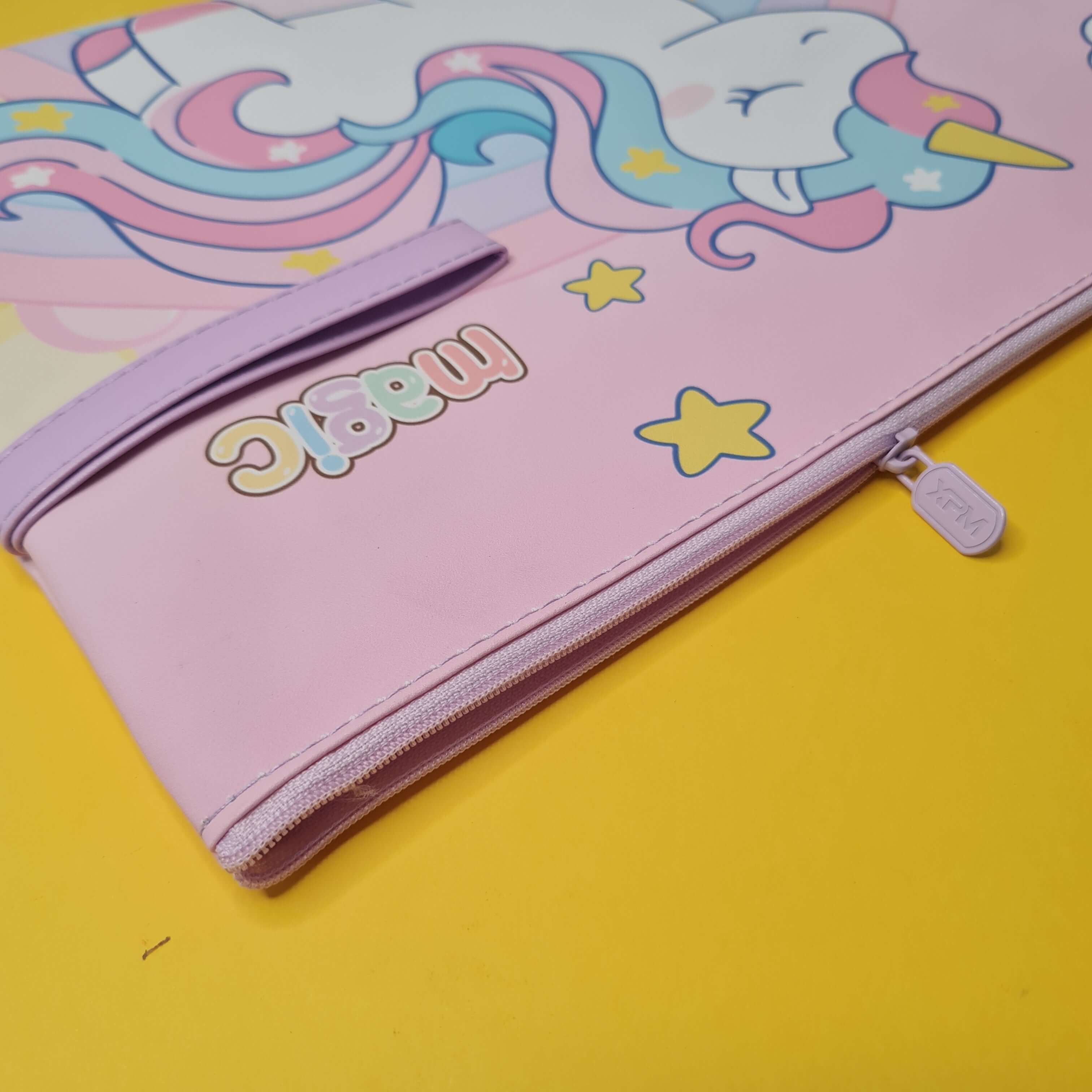 Pink pencil case with unicorn design and 'magic' text on a yellow background