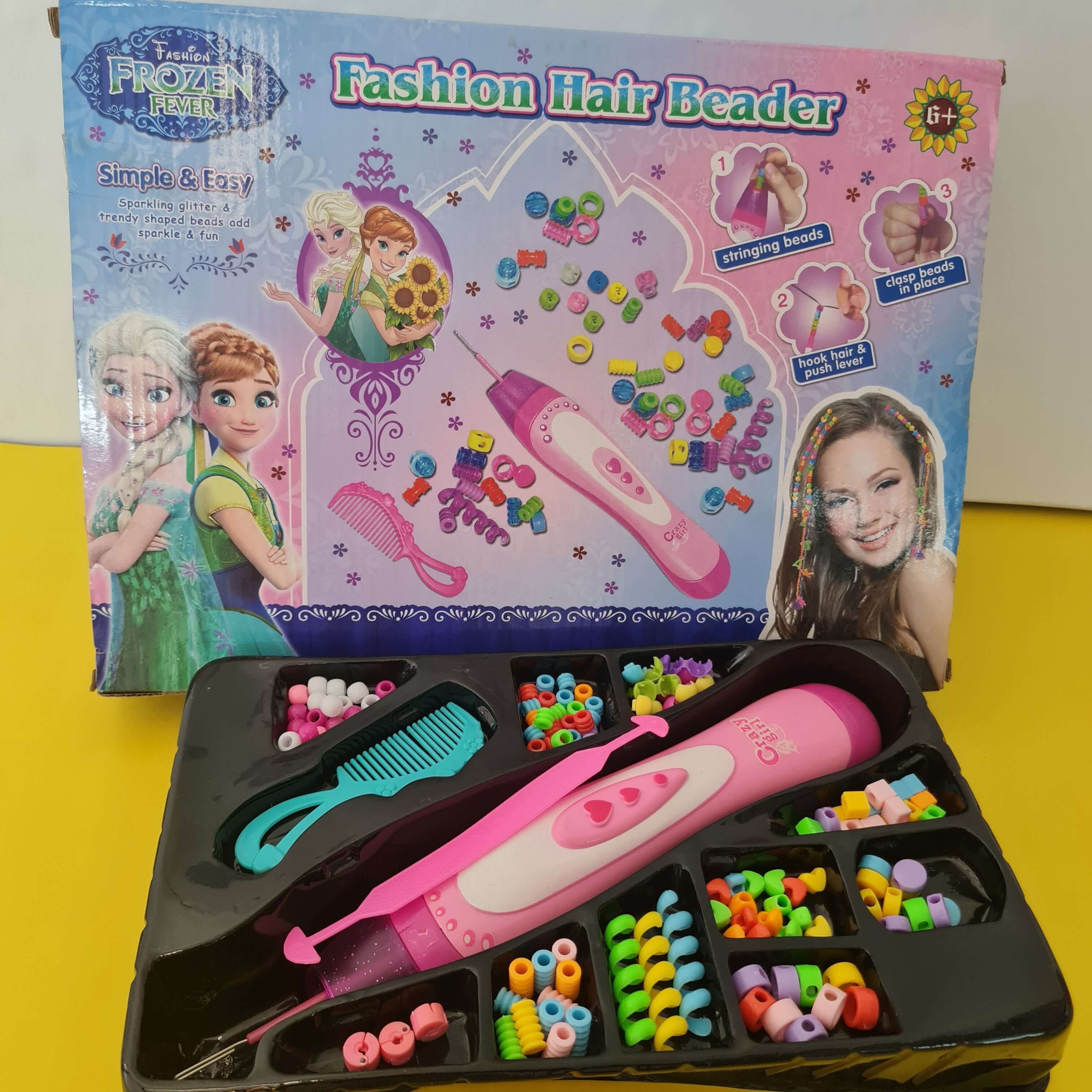 Children's fashion hair beading kit with accessories and packaging on a yellow background