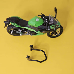 Front view of a bright green die-cast Kawasaki Ninja sports bike toy, showcasing its realistic design and working LED headlights, perfect for kids' playtime from Usmile Toys.