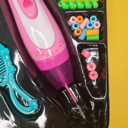 Pink toy hair dryer with accessories on a reflective surface