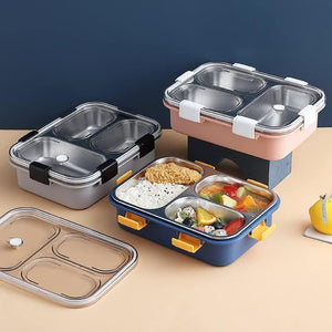Premium quality stainless steel lunch boxes with colorful airtight lids featuring white, black, and yellow clasps, perfect for kids and adults, displayed neatly alongside healthy meals including rice, fried snacks, fresh fruits, and soup. These stylish and durable lunch containers are ideal for school, office, and travel use. Available at www.usmile.toys, your trusted online store for toys, kids stationery, return gifts, baby products, and essentials. Enhance your lunchtime experience with our leakproof, mu