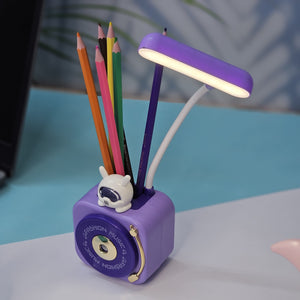 Usmile Toys 3-in-1 multi-functional LED desk lamp in a vibrant teal color, featuring a flexible gooseneck light, an integrated pencil sharpener, and a convenient pen holder with a cute little bunny charm. Ideal for kids' study desks, homework, and creative activities, promoting organization and bright illumination." www.usmile.toys