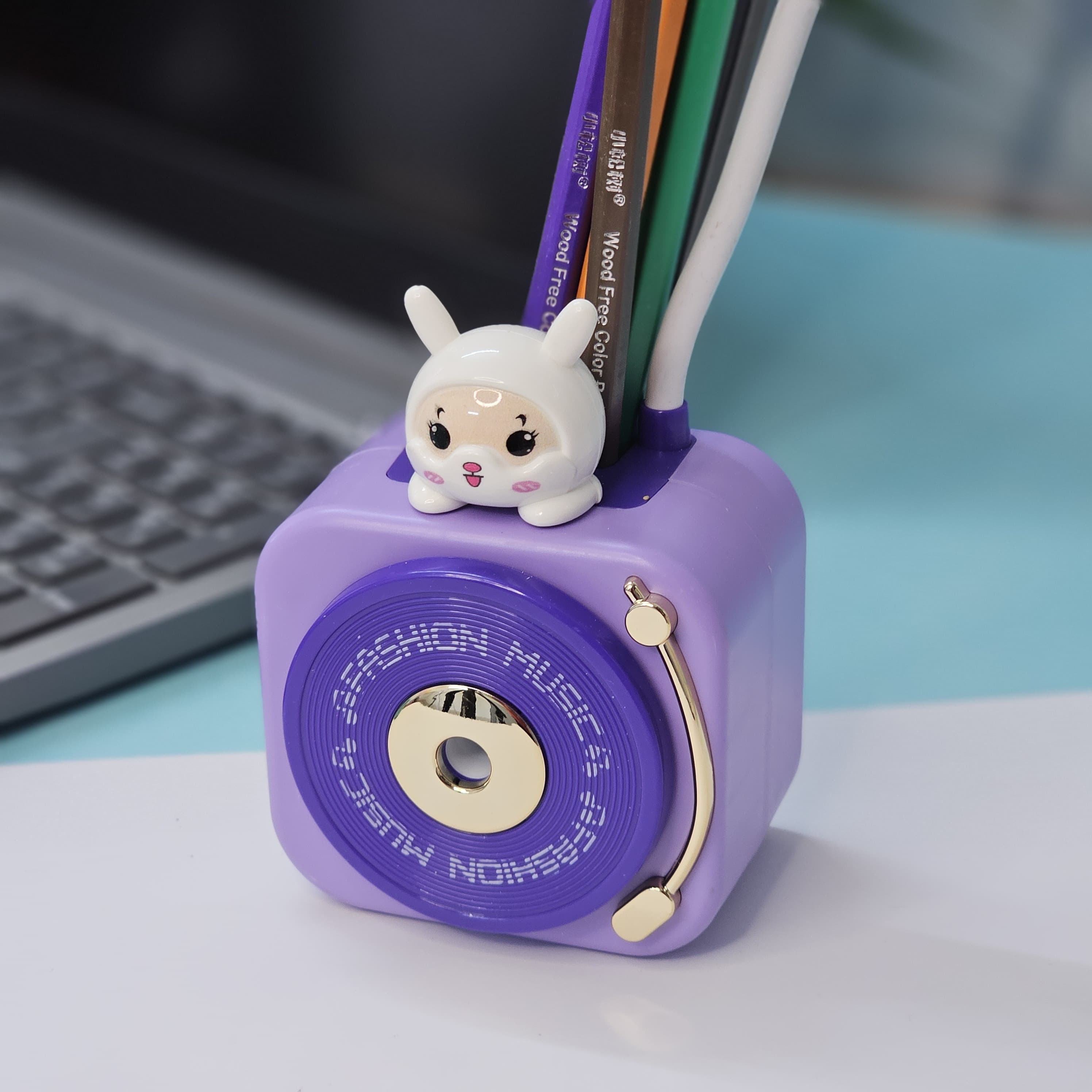 Usmile Toys 3-in-1 multi-functional LED desk lamp in a vibrant teal color, featuring a flexible gooseneck light, an integrated pencil sharpener, and a convenient pen holder with a cute little bunny charm. Ideal for kids' study desks, homework, and creative activities, promoting organization and bright illumination." www.usmile.toys