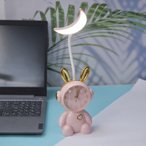 Buy the Usmile Toys adorable pink bunny clock with moon night light for your child's room. This fun alarm clock and soft lamp helps create a soothing bedtime routine." www.usmile.toys