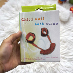 Blue anti-lost wrist safety strap connecting an adult's hand to a child's hand, featuring comfortable wrist cuffs and a coiled wire, designed for keeping toddlers and kids safe in public, available from Usmile Toys www.usmile.toys