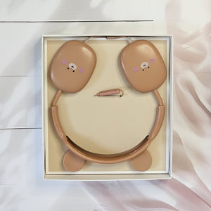 BuBu Bear wired headphones for kids, featuring a cute rabbit design in soft pink, with a detachable microphone and a visible audio jack, displayed on a white surface with floral decorations, highlighting the product's features and aesthetic appeal." www.usmile.toys