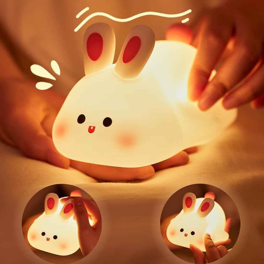 "Adorable glowing white silicone night lamp for kids, shaped like a cute rabbit with big ears and a cheerful face, being gently held. Provides a soft, comforting light for bedrooms from uSmile.toys." www.usmile.toys