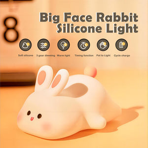 "Adorable glowing white silicone night lamp for kids, shaped like a cute rabbit with big ears and a cheerful face, being gently held. Provides a soft, comforting light for bedrooms from uSmile.toys." www.usmile.toys www.usmile.toys