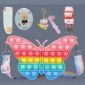 Usmile Toys Kids' rainbow butterfly Pop It fidget sling bag, featuring vibrant colors, shown with matching comb and character keychains." www.usmile.toys