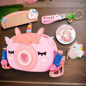 "Usmile Toys Kids' pink camera-shaped silicone bag featuring a unicorn horn and ears, displayed with matching unicorn comb and keychains." www.usmile.toys
