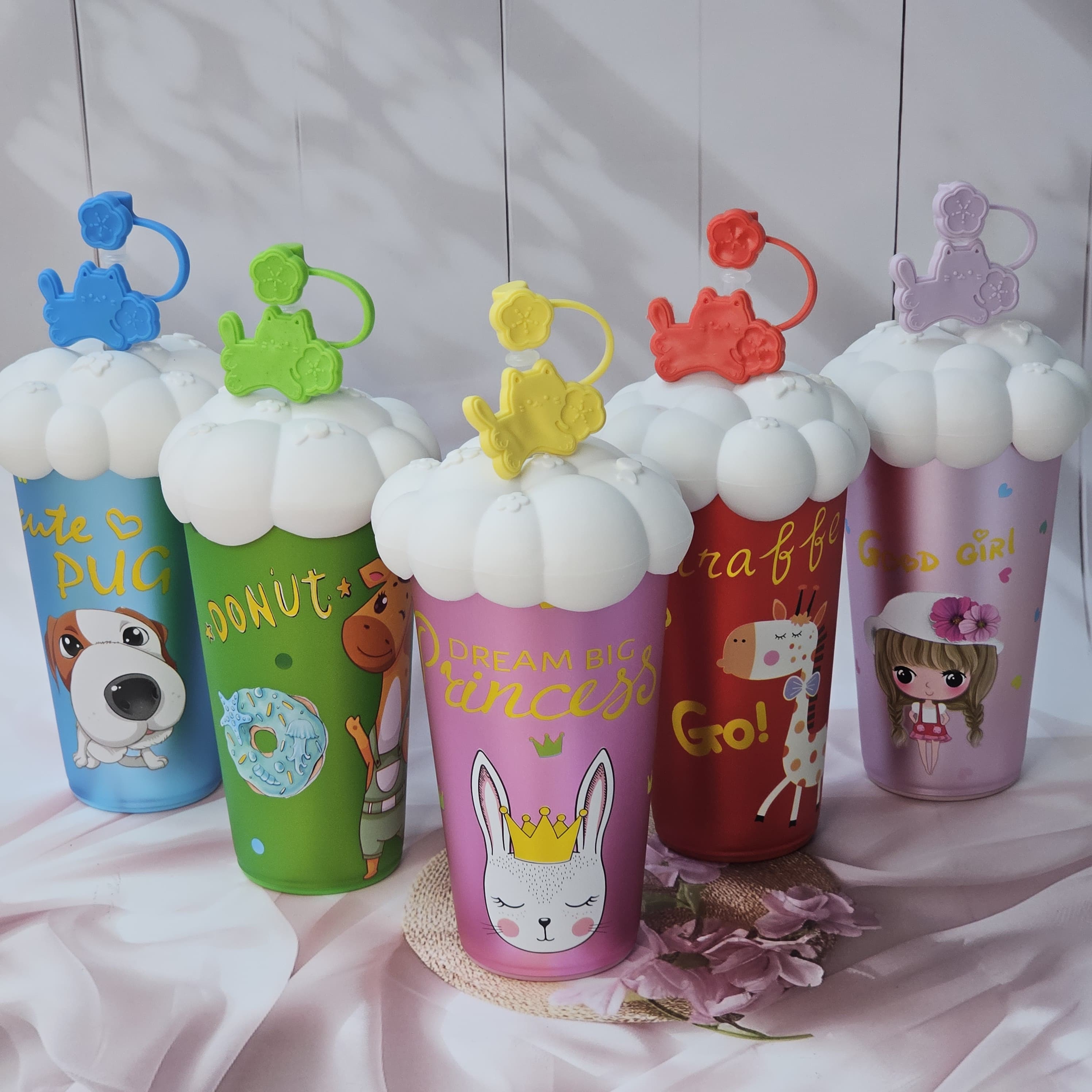 Set of five colorful Usmile Toys Cartoon Insulated Fancy Sippers for kids, each with unique animal or character designs and whimsical cloud-shaped lids with decorative straw toppers." www.usmile.toys