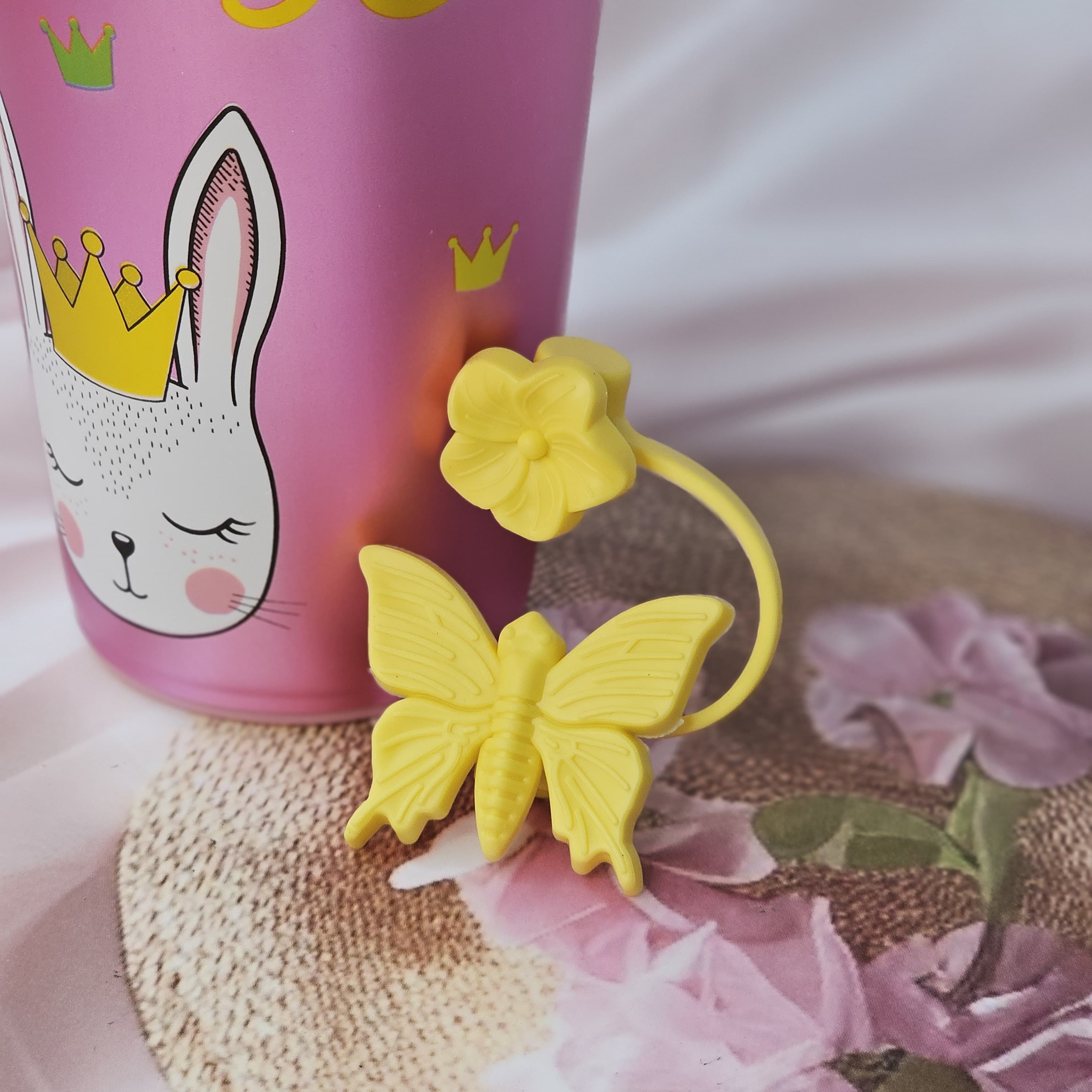 Usmile Toys 'Fun & Functional' kids' drinkware: a mix of insulated cartoon tumblers in blue, green, pink, red, and purple, featuring a pug, donut, bunny, giraffe, and girl design respectively, all with white cloud lids." www.usmile.toys