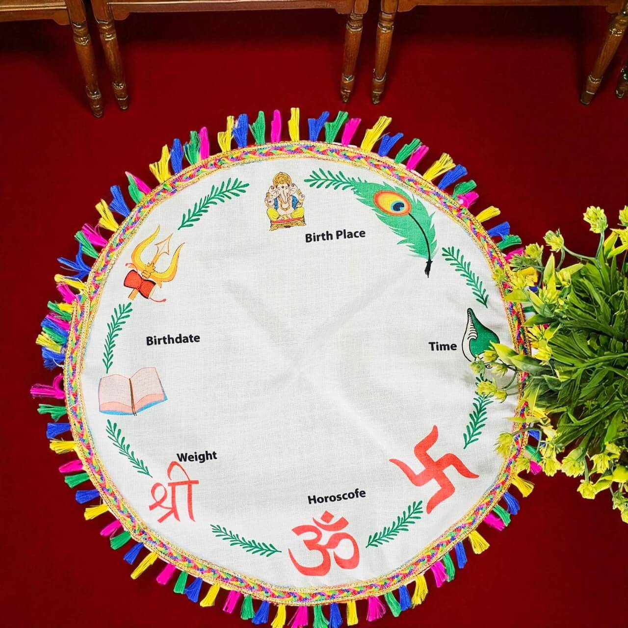 Decorative round chart with colorful tassels on a red surface