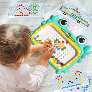 Child using a dot-to-dot toy with colorful markers on a light wooden surface.