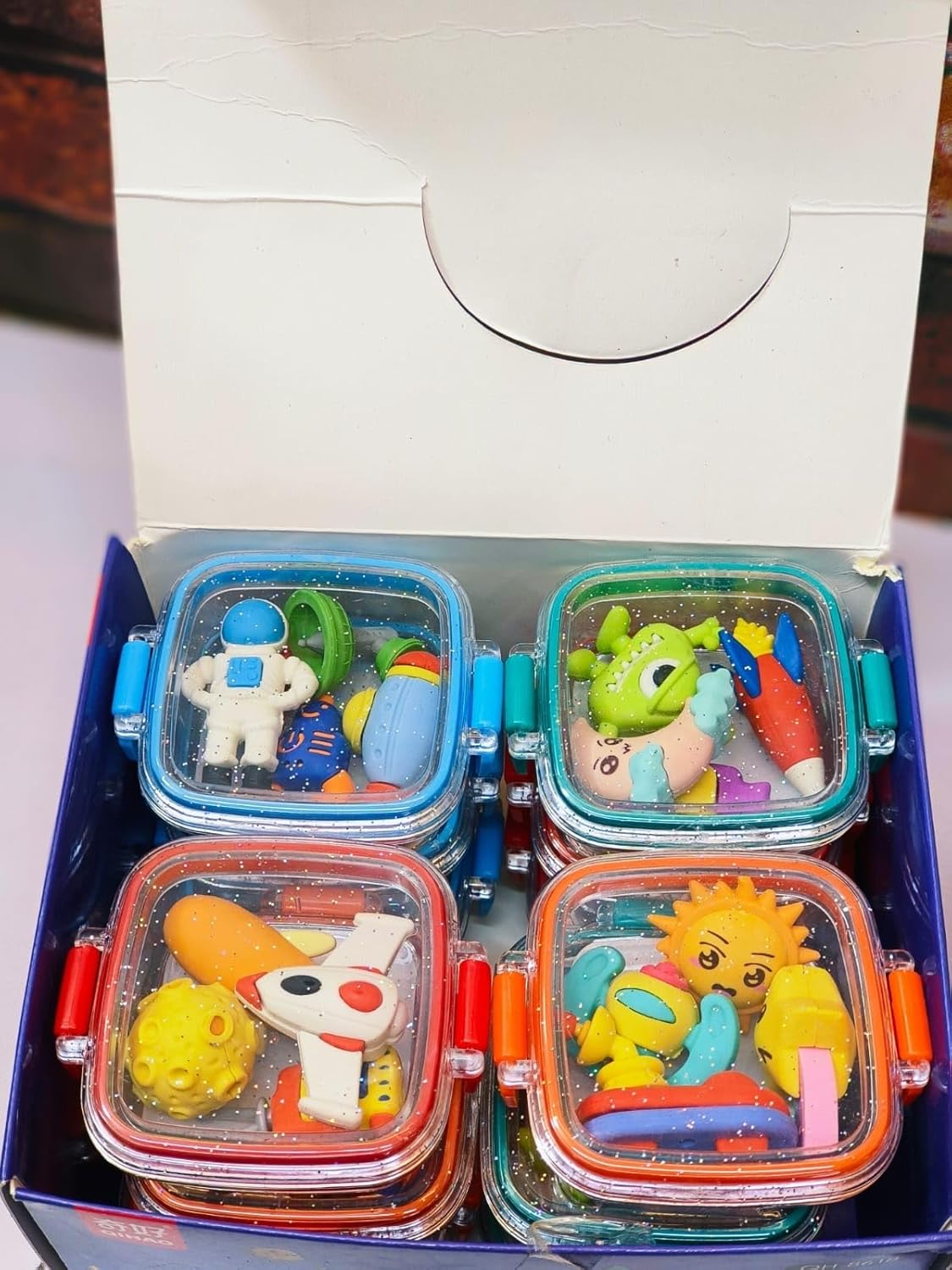 Fun, colorful erasers in animal and space shapes, packaged in small, square bento boxes. www.usmile.toys