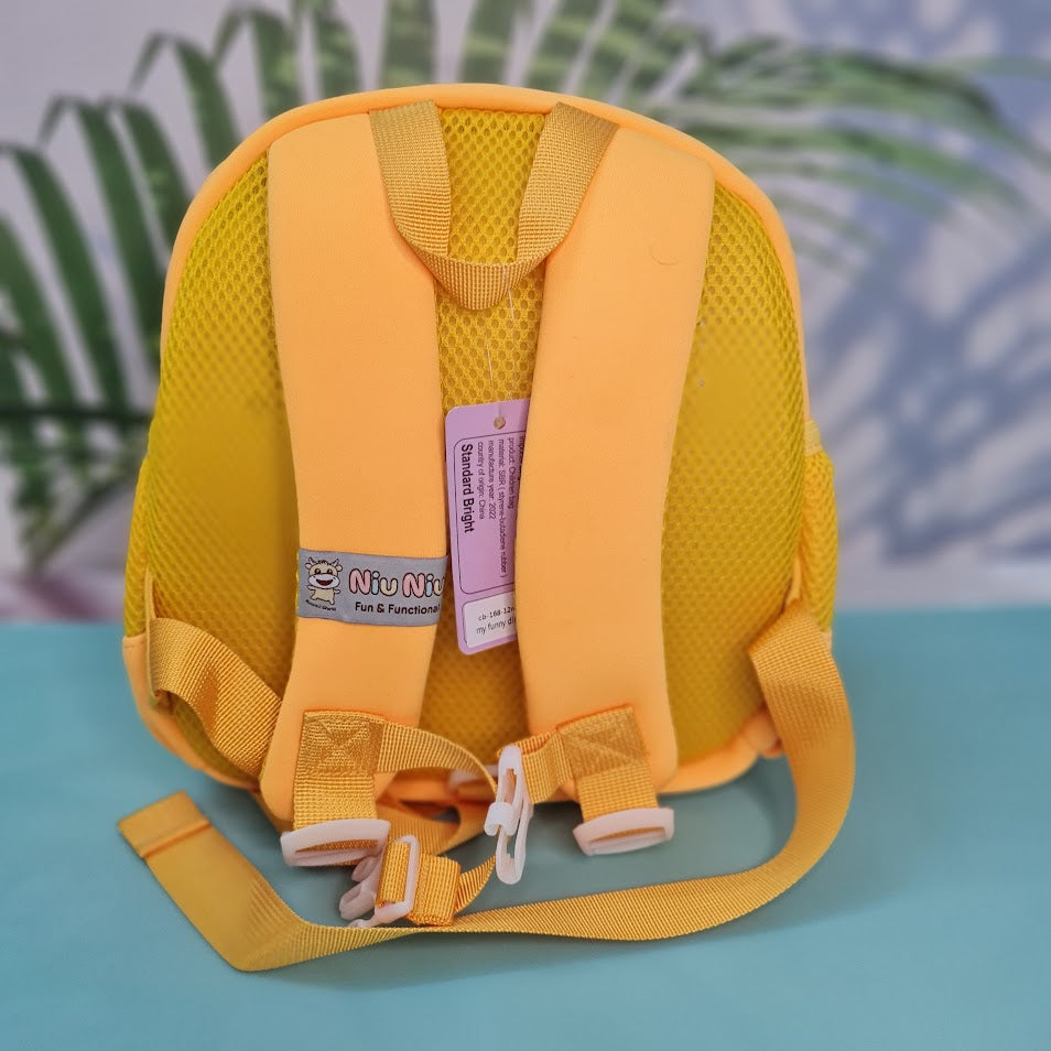 Small, yellow backpack for children featuring a large green dinosaur applique with red spikes and white teeth on the front pocket. Above the dinosaur is embroidered yellow cursive text that reads "My Funny Dino". The backpack has yellow straps and yellow mesh side pockets