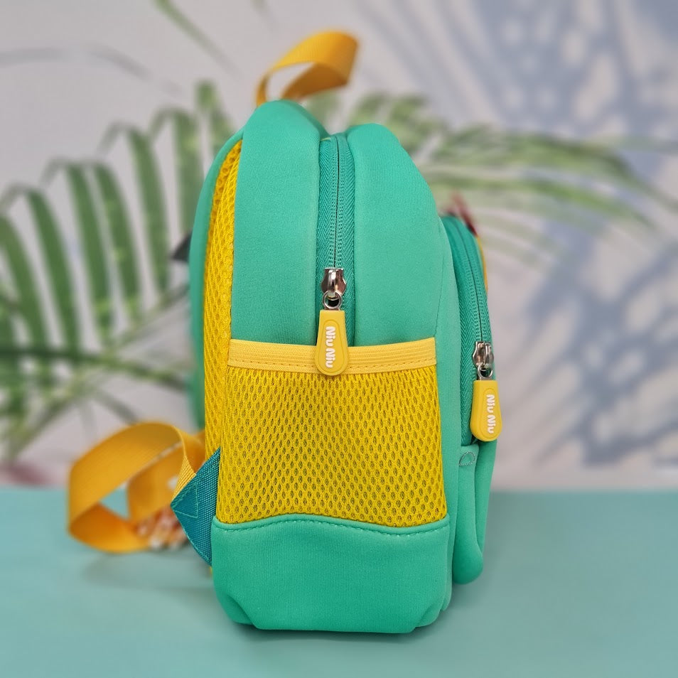 Small, teal backpack for children featuring a large orange dinosaur applique with red spikes and white teeth on the front pocket. Above the dinosaur is embroidered teal cursive text that reads "My Funny Dino". The backpack has yellow straps and yellow mesh side pockets