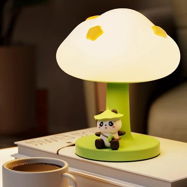 Cute green and white silicone bedside table lamp for kids, with a mushroom-shaped top and a small 'PoPo Panda' figurine sitting at its base. Provides a gentle glow. Ideal for a child's bedroom from uSmile.toys." www.usmile.toys