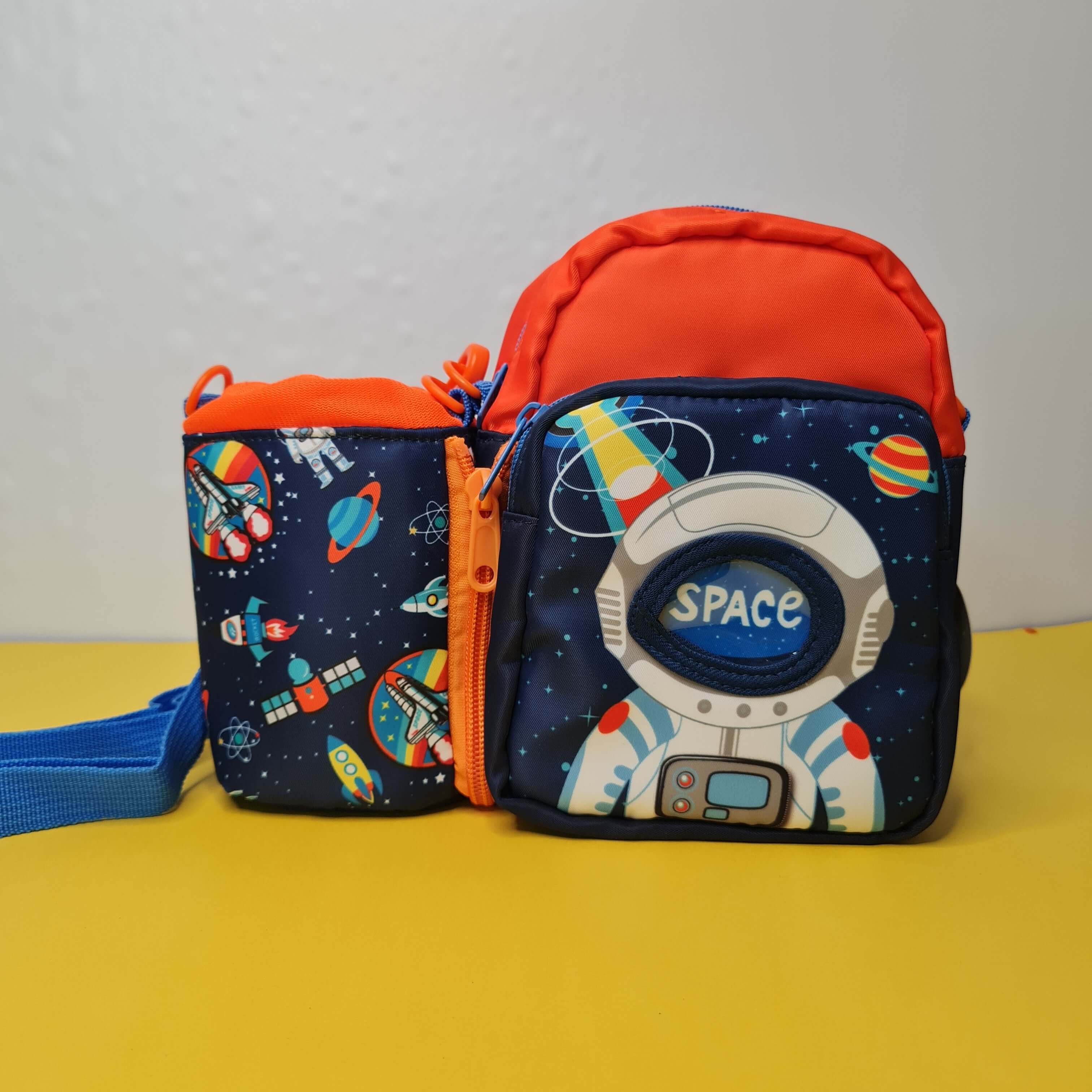 Children's navy blue and orange lunch bag set with "SPACE" astronaut and planet print, ideal for tiffins and water bottles. www.usmile.toys