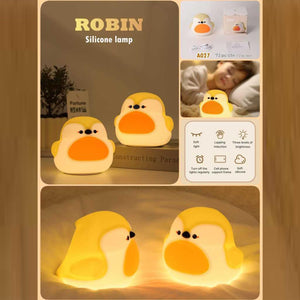 Two adorable glowing yellow and white silicone night lamps for kids, shaped like cute, plump birds or chicks with orange beaks. Ideal for a soft, comforting bedroom light from uSmile.toys." www.usmile.toys
