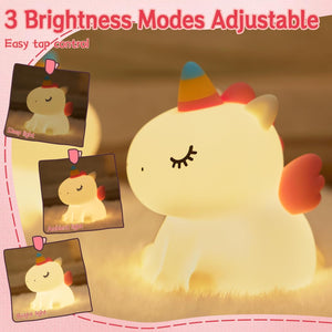 Adorable glowing white silicone night lamp for kids, shaped like a cute sitting unicorn with a colorful horn and pink wings. Provides a soft, comforting light for bedrooms. From uSmile.toys www.usmile.toys