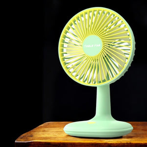 Bright green and yellow USB rechargeable mini desktop cooling fan, ideal for office desks, homes, or travel. Compact and portable fan from uSmile.toys." www.usmile.toys