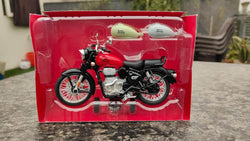 High-quality miniature replica of a Royal Enfield motorcycle in red, displayed with its retail box and two additional colored fuel tanks, offering pull-back action for interactive play from Usmile Toys www.usmile.toys