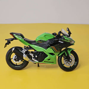 green and black toy motorbike, a die-cast model designed for kids with fun pull-back action and interactive LED lights, available at Usmile Toys.