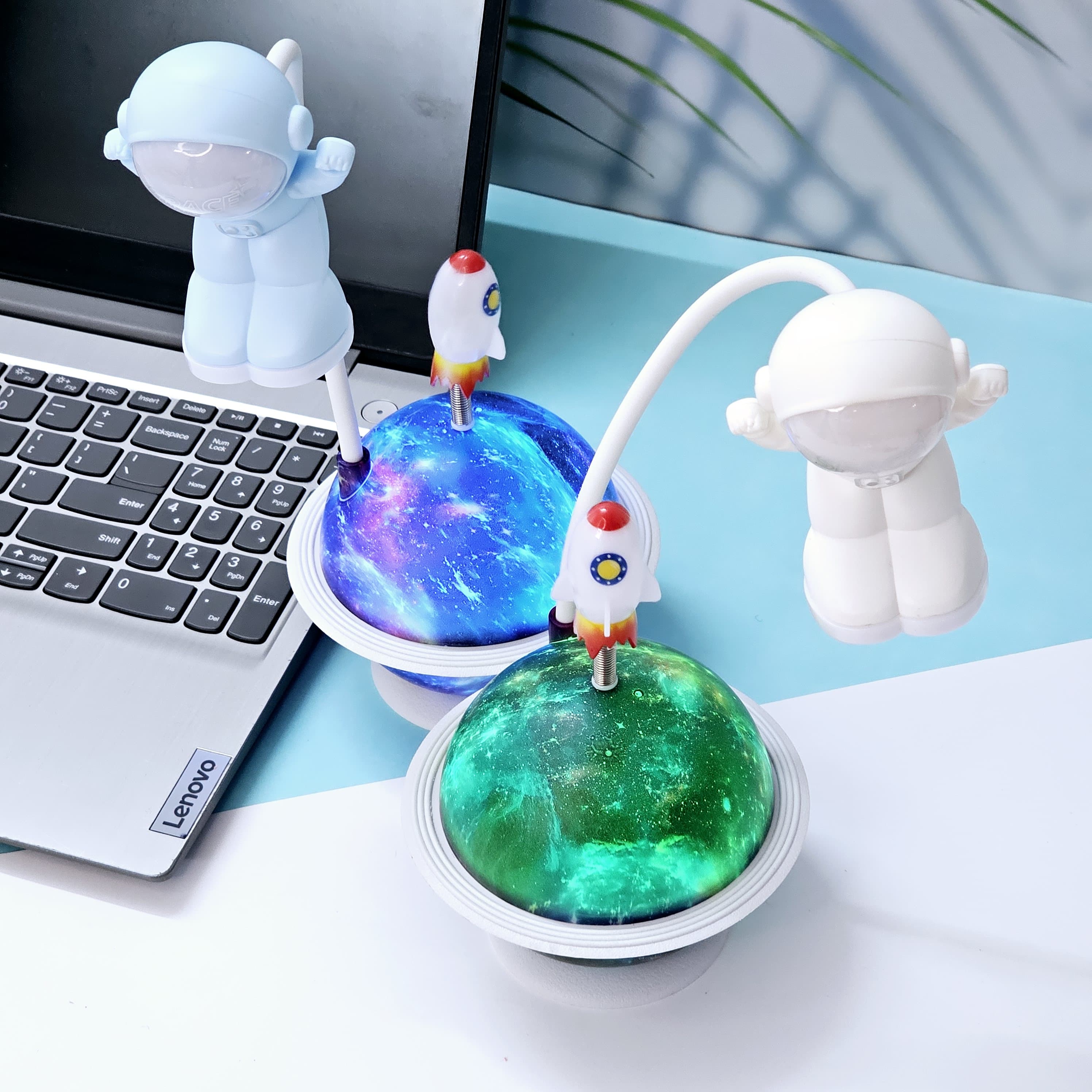 Interactive space-themed lamp for kids: a Usmile Toys astronaut figure attached to a vibrant, illuminated planet base, bringing a celestial glow to any desk."