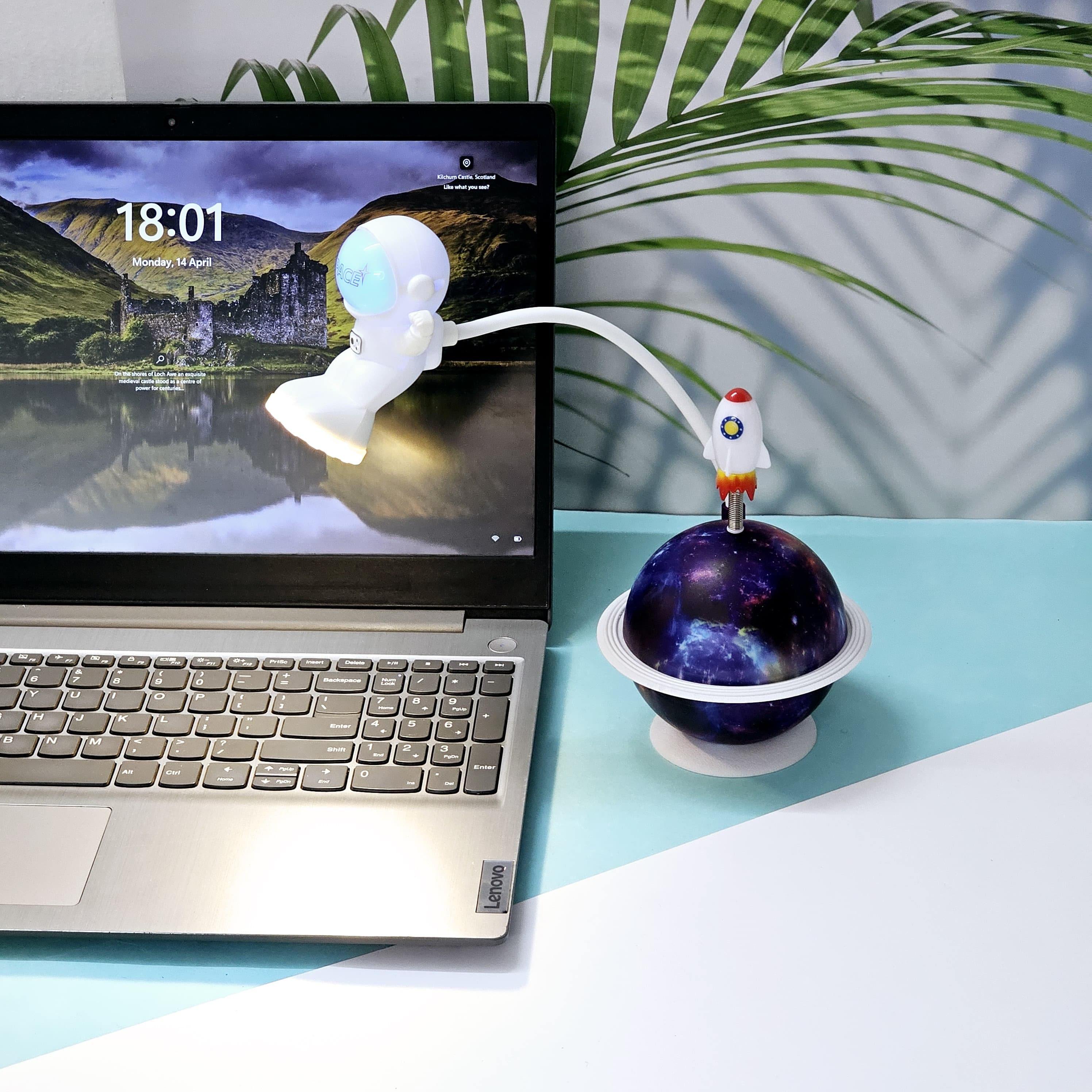 Interactive space-themed lamp for kids: a Usmile Toys astronaut figure attached to a vibrant, illuminated planet base, bringing a celestial glow to any desk."