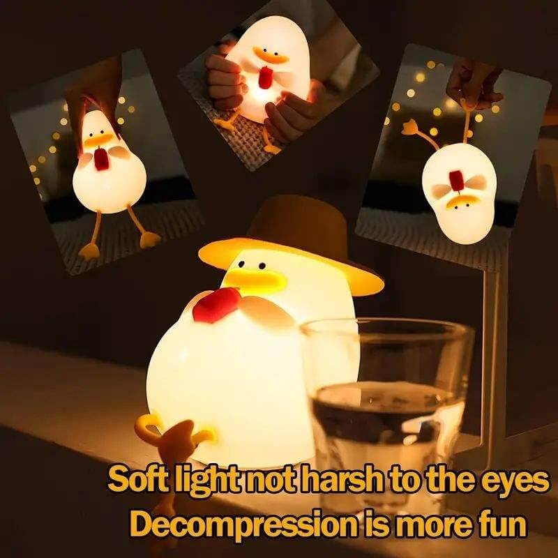 Adorable white silicone duck night lamp wearing a yellow hat and holding a red straw, glowing softly. The top-left inset shows the duck lamp illuminated in a dark room. This charming LED light is perfect for kids' rooms, nurseries, or as a unique gift, providing comforting ambient light. www.usmile.com