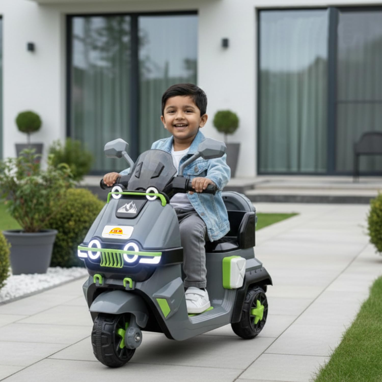 Electric Bike for Kids | Electric Ride-On Scooter for Kids 1 to 6 Years www.usmile.toys Child sitting on a toy motorcycle in front of a modern house.