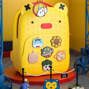 Bright yellow EVA kids school backpack with cartoon character pins and a textured surface, designed to be stylish, durable, and waterproof, perfect for daily school use from Usmile Toys.www.usmile.toys