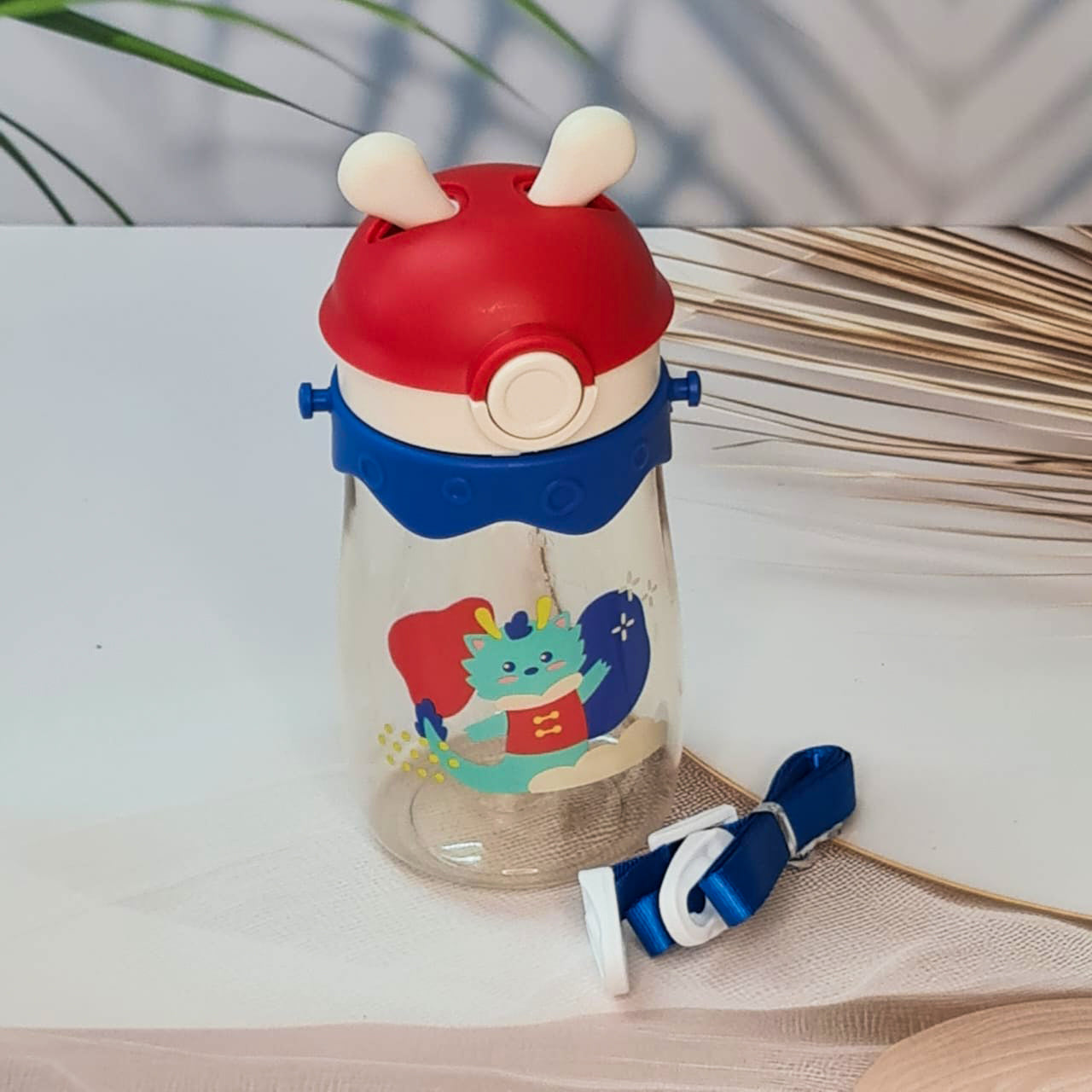 Set of three colorful kids water bottles with cute animal prints, featuring bunny, giraffe, and dragon designs. Each bottle includes a playful lid with 3D cartoon ears and comes with a matching strap for easy carrying. These BPA-free, leak-proof bottles are ideal for school, travel, and outdoor use—perfect addition to kids stationery and daily essentials