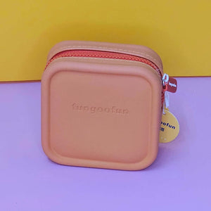 Pink square pouch with zipper on a purple and yellow background
