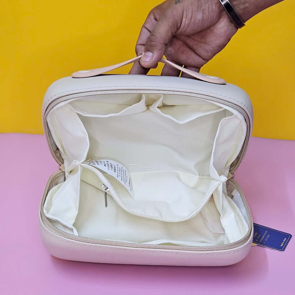 Open beige travel case with a yellow background