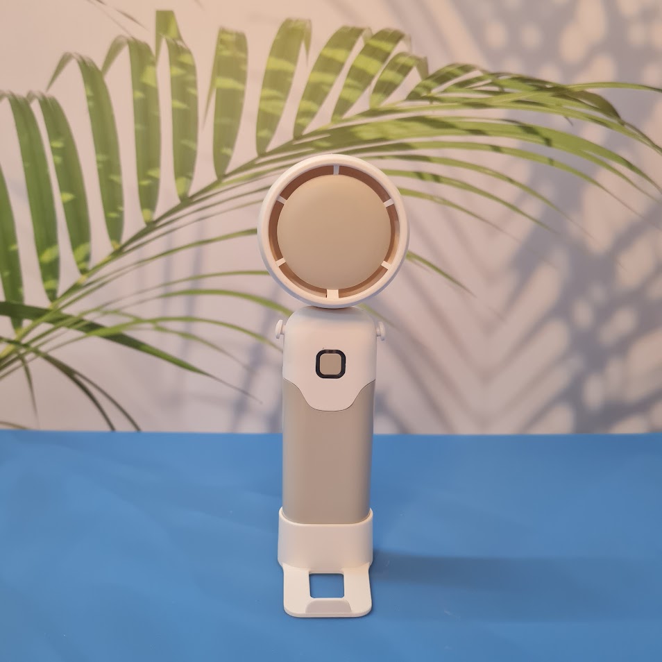 Colorful collection of portable bladeless mini fans for kids in pastel pink, green, blue with bear ears, and cream, designed with a child-safe bladeless head and single-button operation. These rechargeable USB fans are ideal for travel, school desks, or bedtime comfort, offering quiet and efficient cooling in a cute, compact design. Perfect return gift or utility item for children, available at U Smile Toys online store