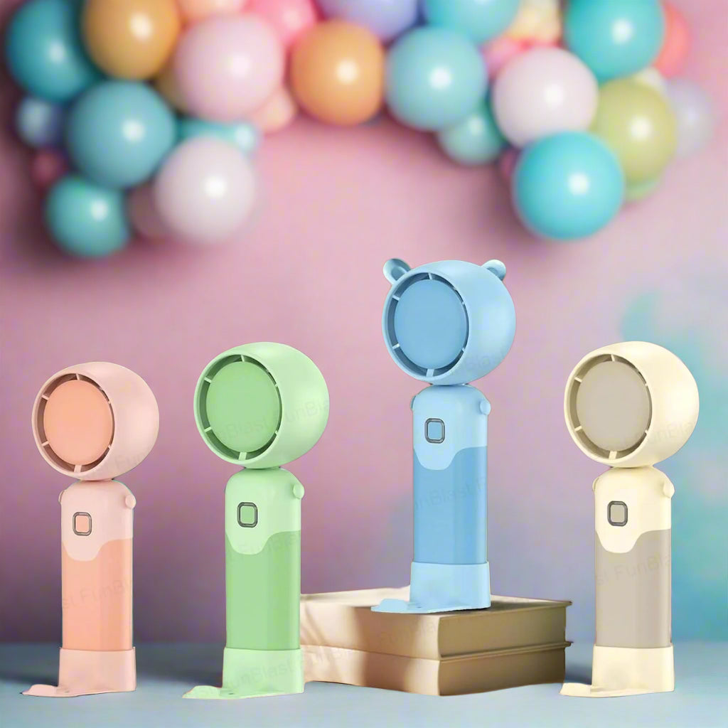 Colorful collection of portable bladeless mini fans for kids in pastel pink, green, blue with bear ears, and cream, designed with a child-safe bladeless head and single-button operation. These rechargeable USB fans are ideal for travel, school desks, or bedtime comfort, offering quiet and efficient cooling in a cute, compact design. Perfect return gift or utility item for children, available at U Smile Toys online store