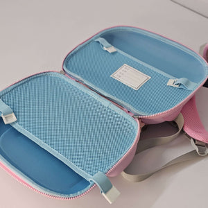 Blue and pink travel pouch with mesh compartments on a light gray background