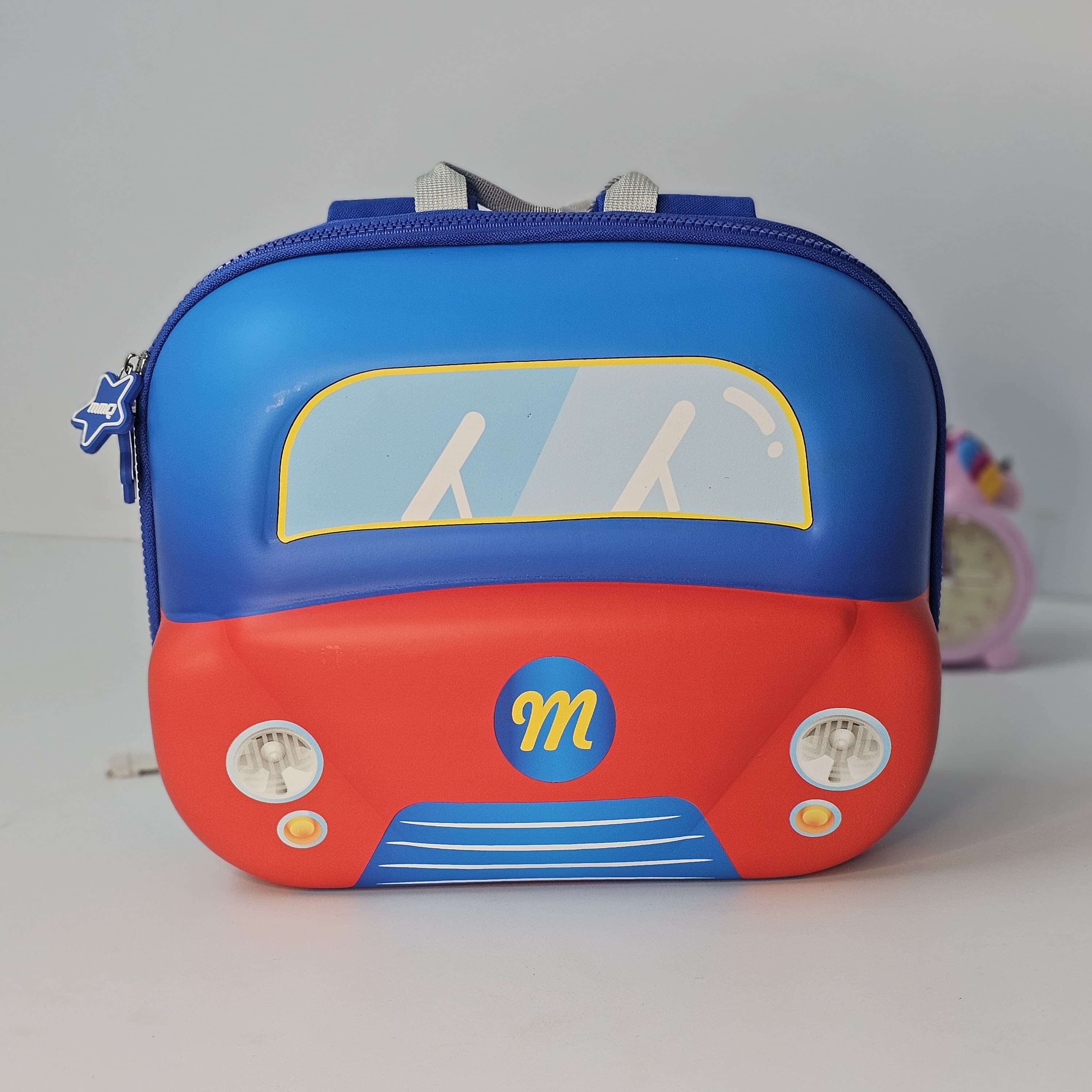 Children's backpack designed like a red car with blue top on a gray background