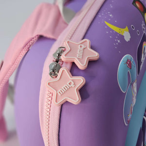 Close-up of a purple bag with pink star-shaped zipper pulls and cartoon designs.