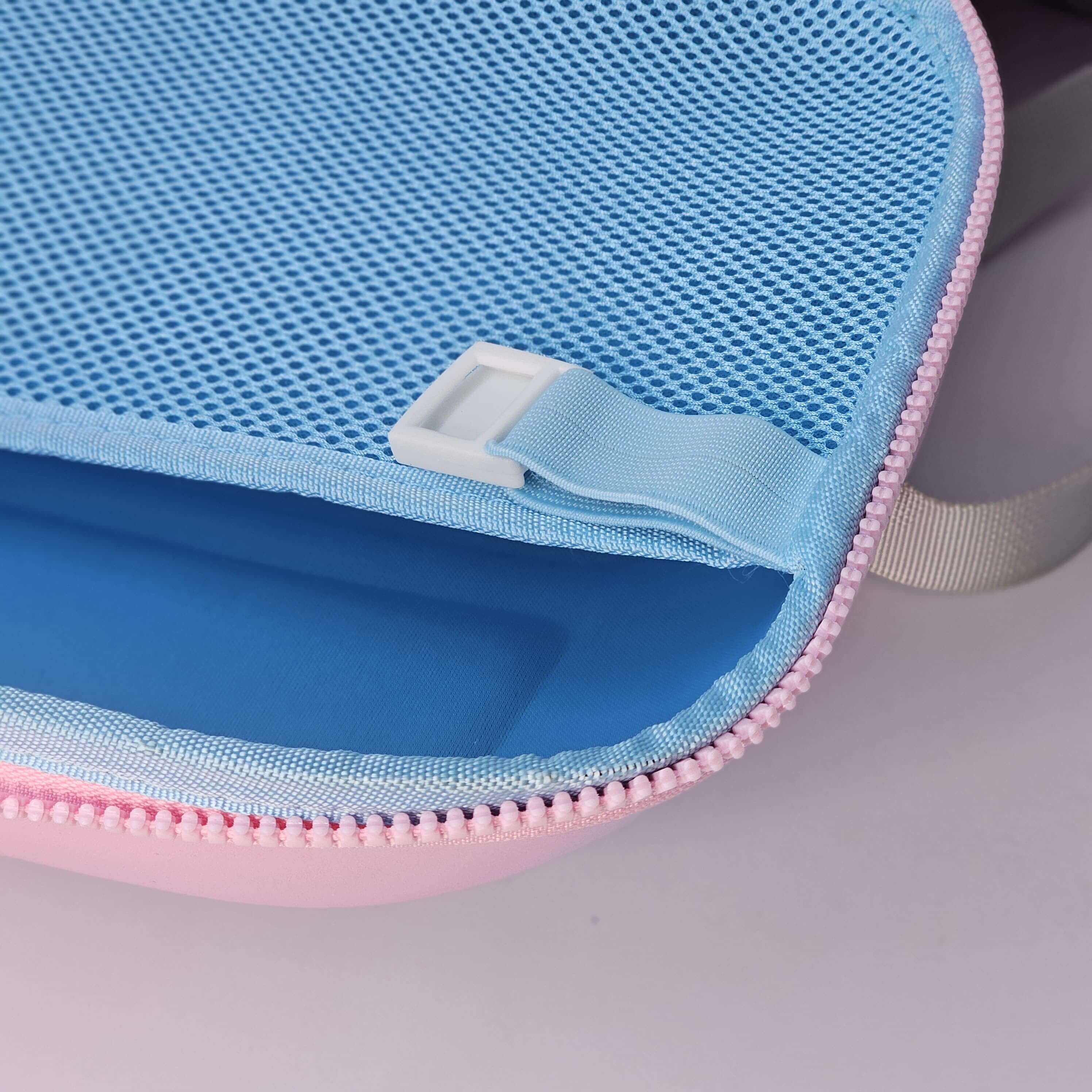 Close-up of a blue and pink zippered pouch on a gray background