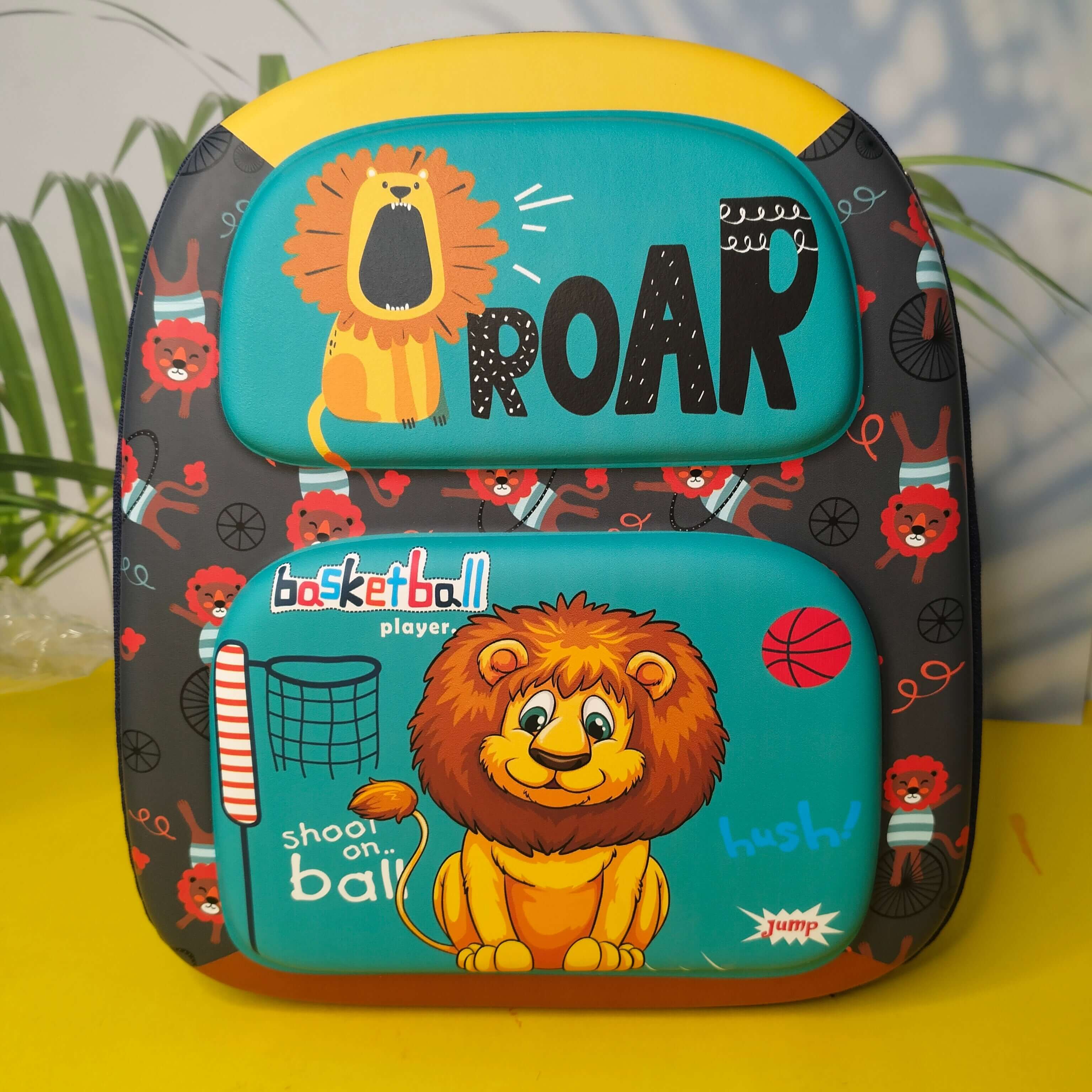 Backpack with lion design and 'ROAR' text on a yellow surface
