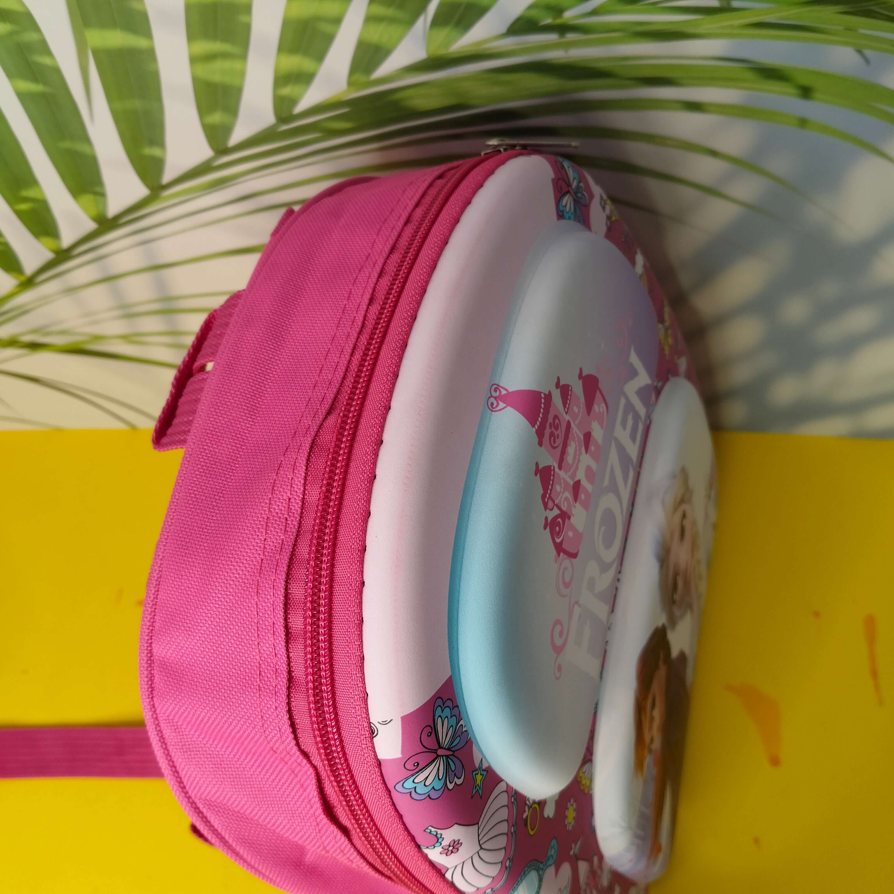 Pink Frozen-themed lunch bag with a character on a yellow surface