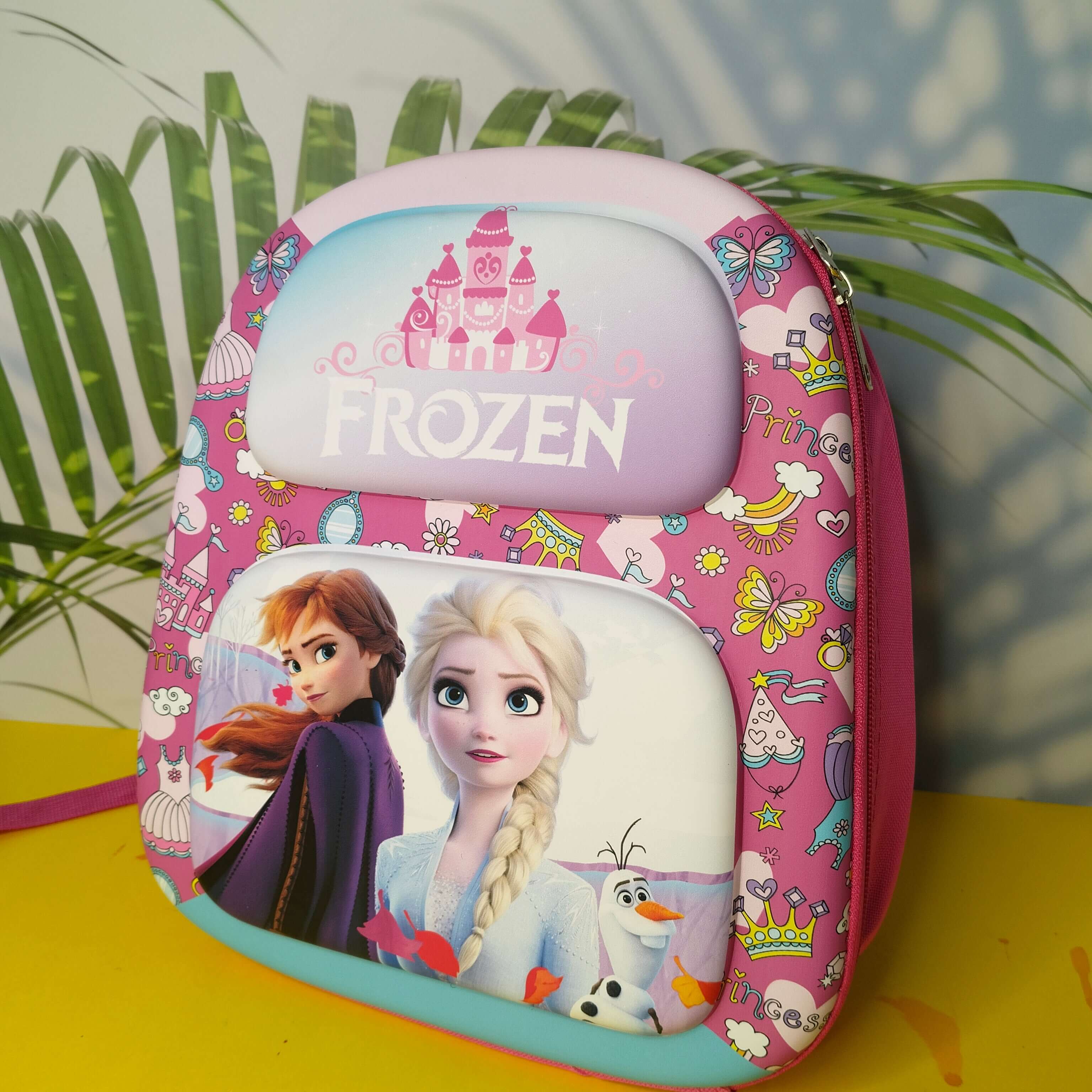 Pink 'Frozen' themed pouch with characters on a yellow surface